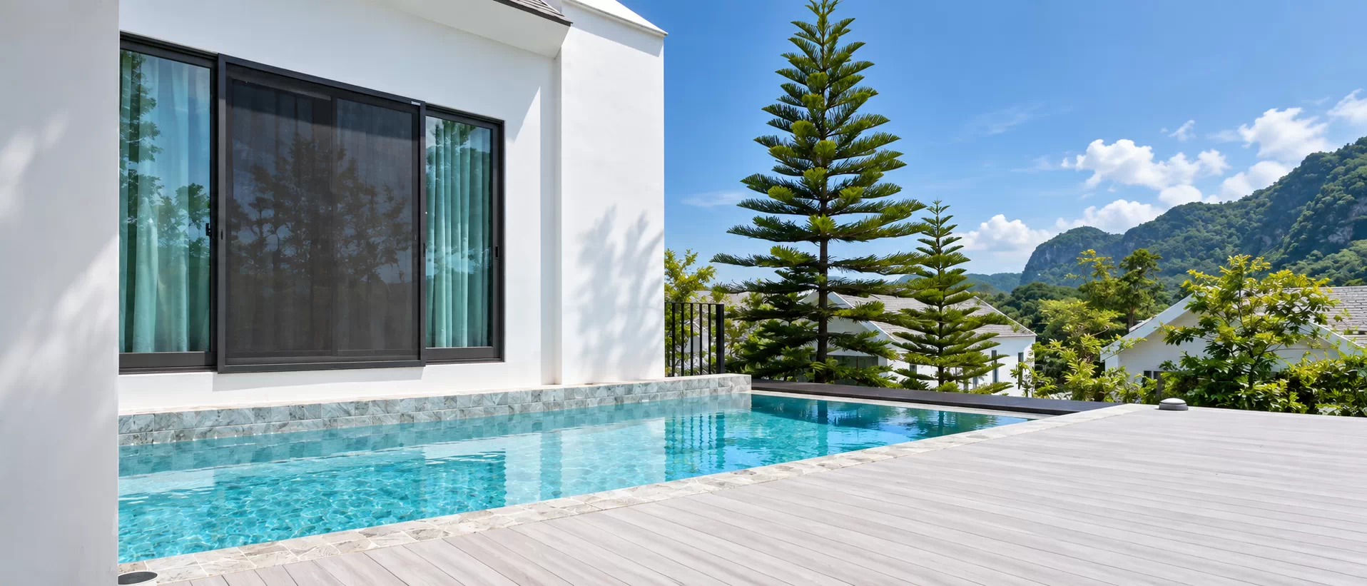Aludeck wood-grain aluminium decking around a pool and garden